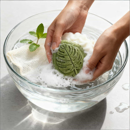 Hands lathering a mint shampoo bar in water — natural shampoo for oily hair with rich, creamy foam