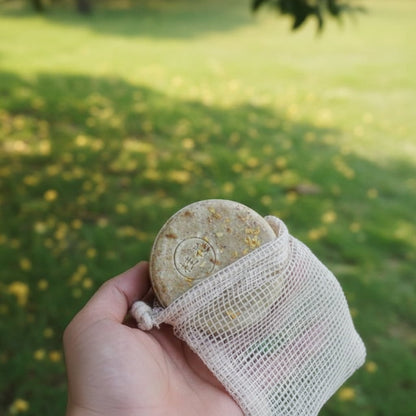 Solid botanical shampoo bar in a sisal pouch, gentle cleansing for frizzy and damaged hair